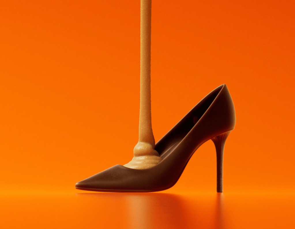 Still of stiletto shoe made out of chocolate being filled with peanut butter.